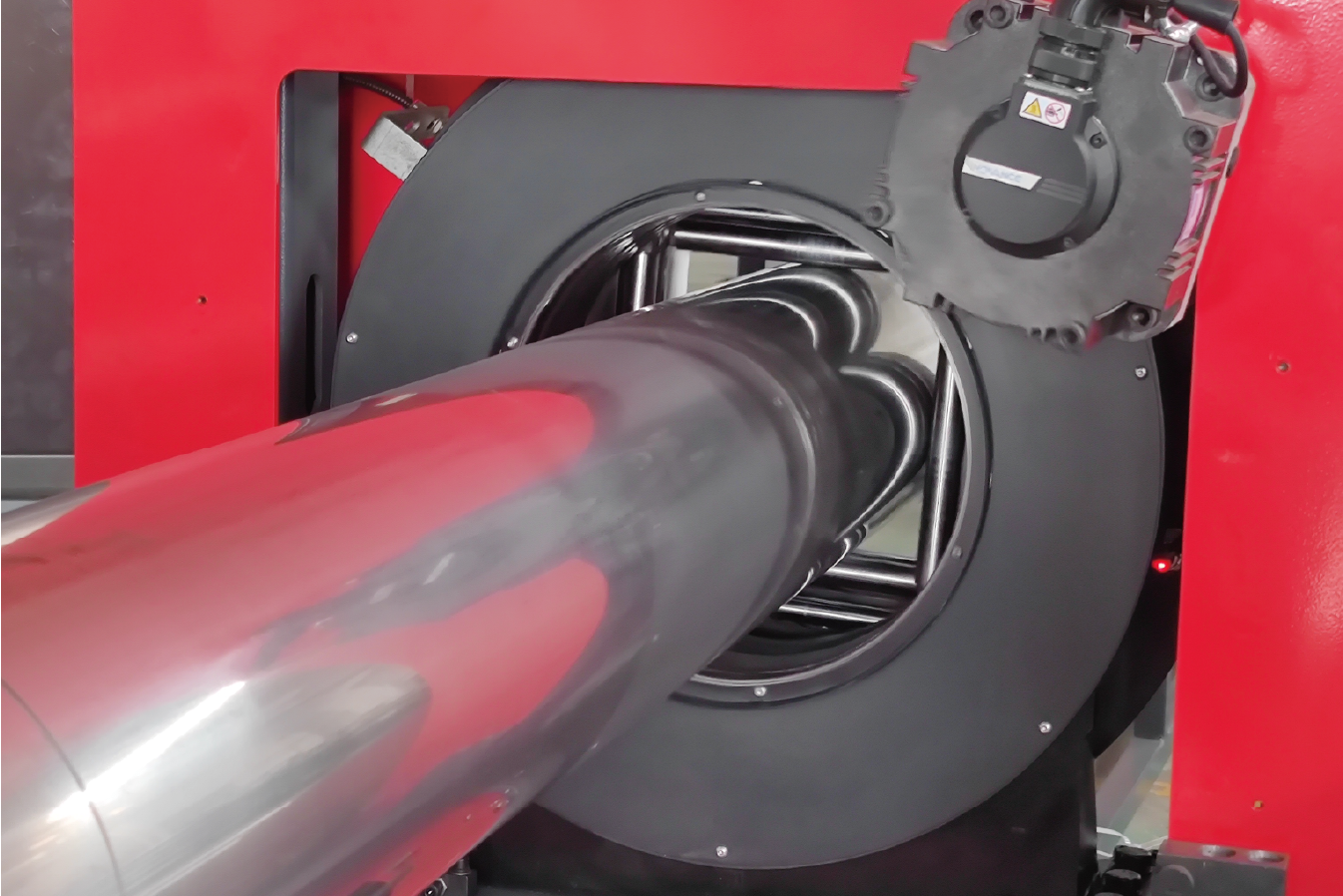Full-length view of MZBNL laser tube cutting production line. Workers and automated systems collaborate to achieve streamlined, high-volume pipe processing.