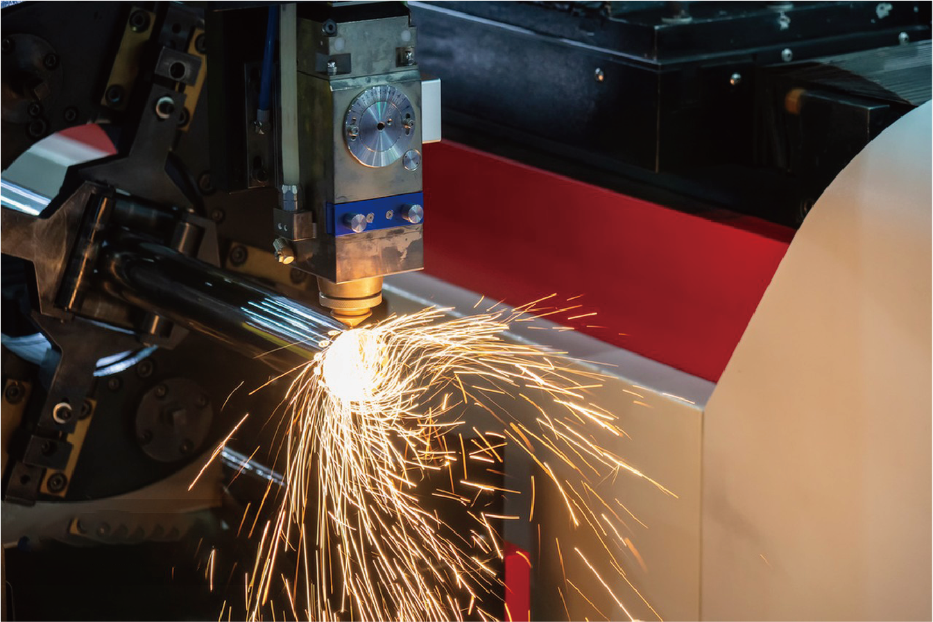 Close-up of BNL laser head cutting metal tube with precision sparks
