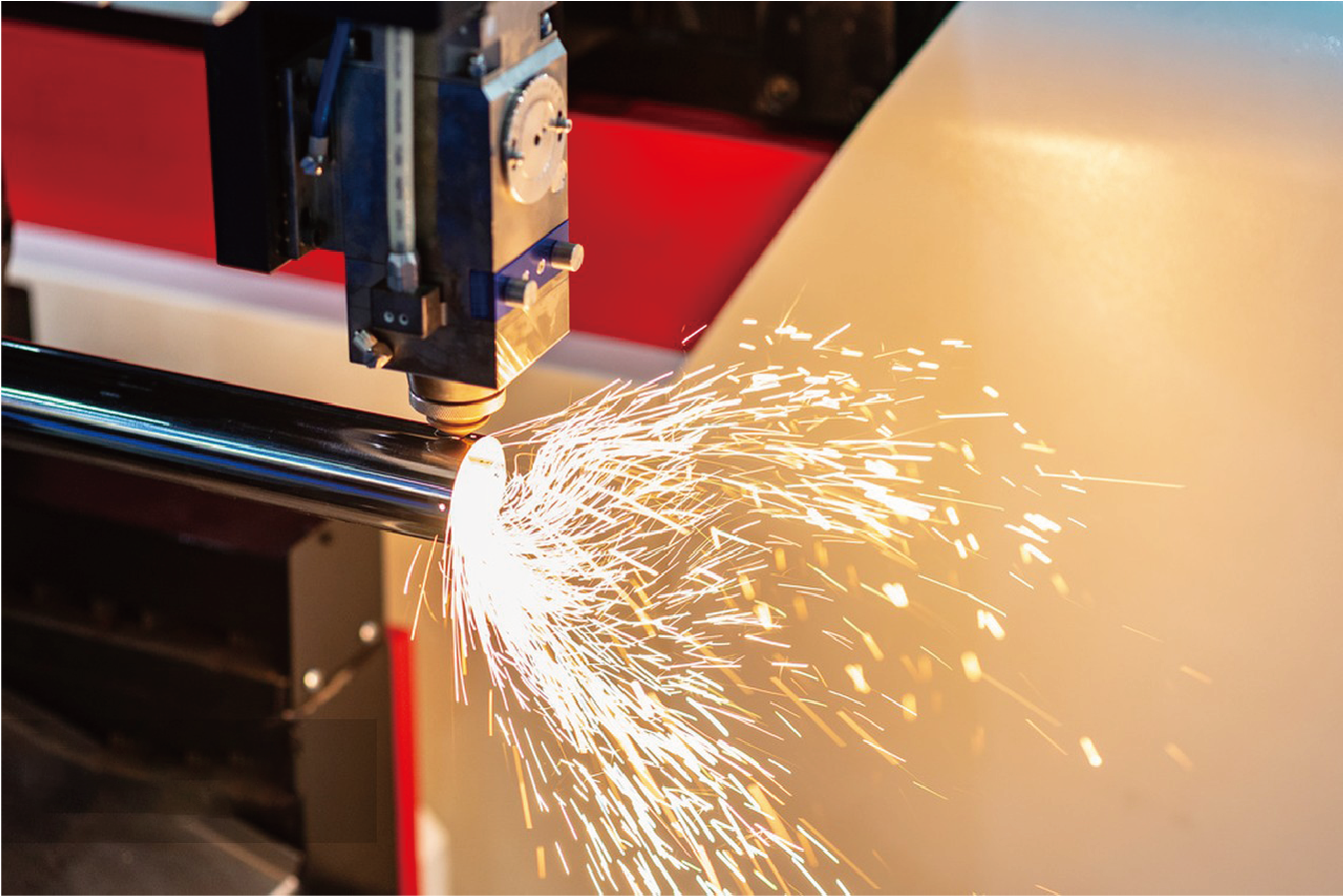 High-performance BNL laser cutter processing steel tube with rotary chuck system and powerful cutting sparks.