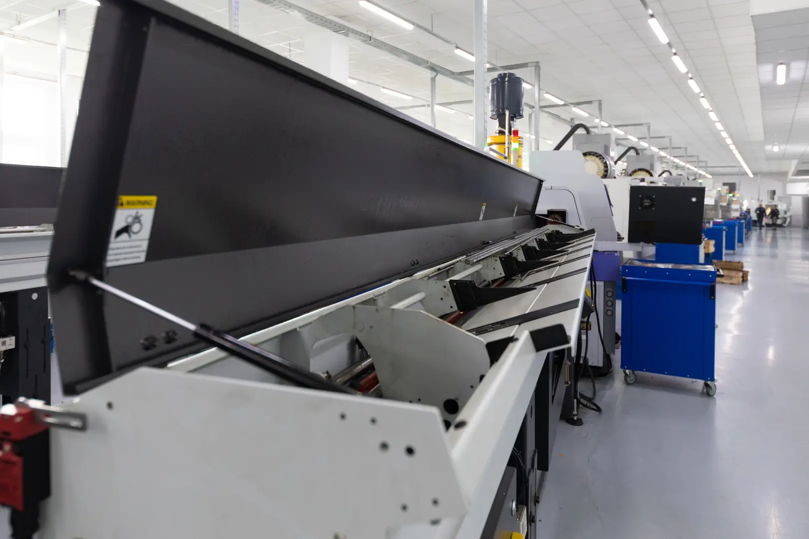 Modern laser tube cutting machine in industrial setting with advanced automation features