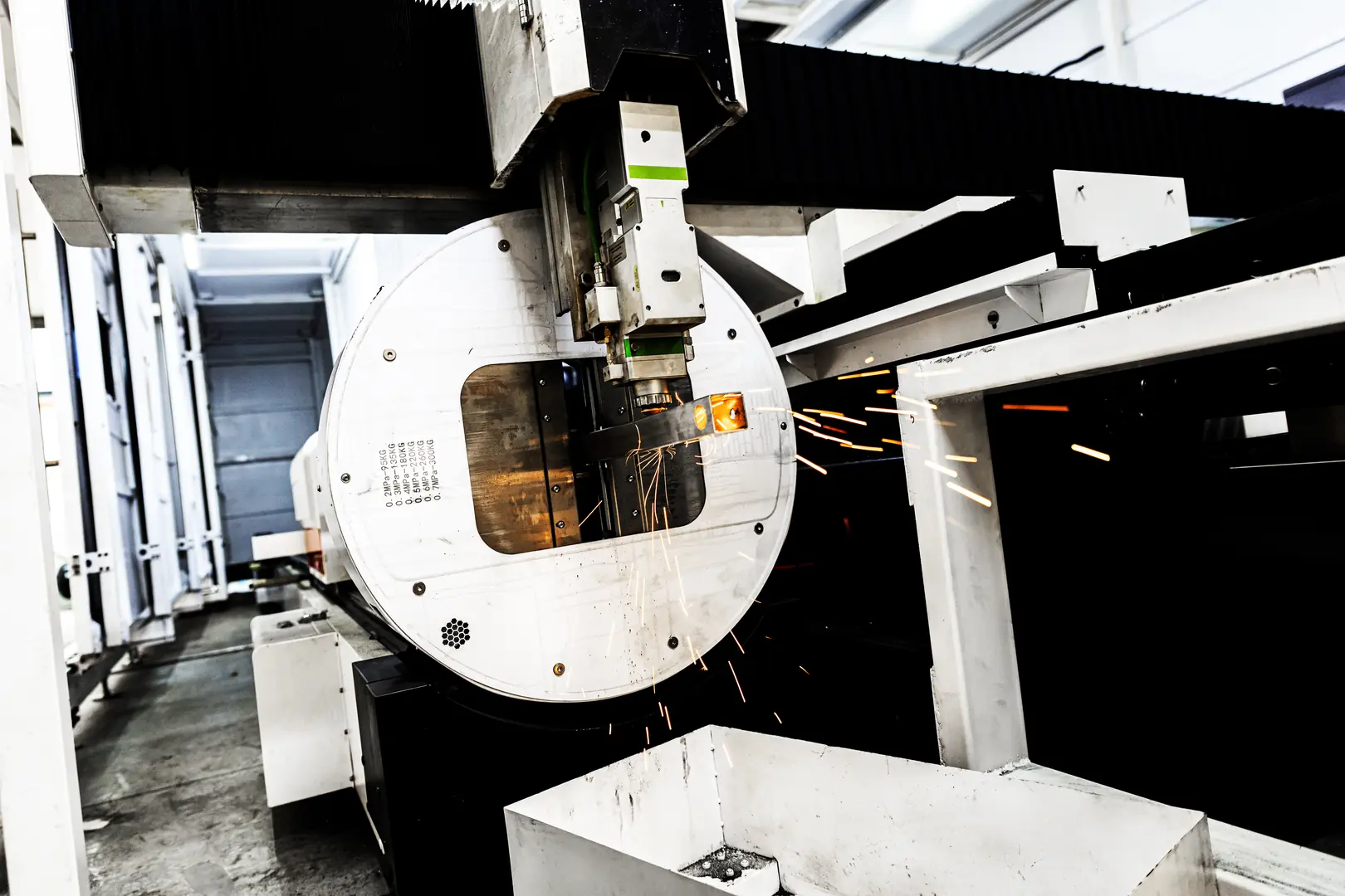 High-tech laser cutting machine slicing metal tube with precision sparks